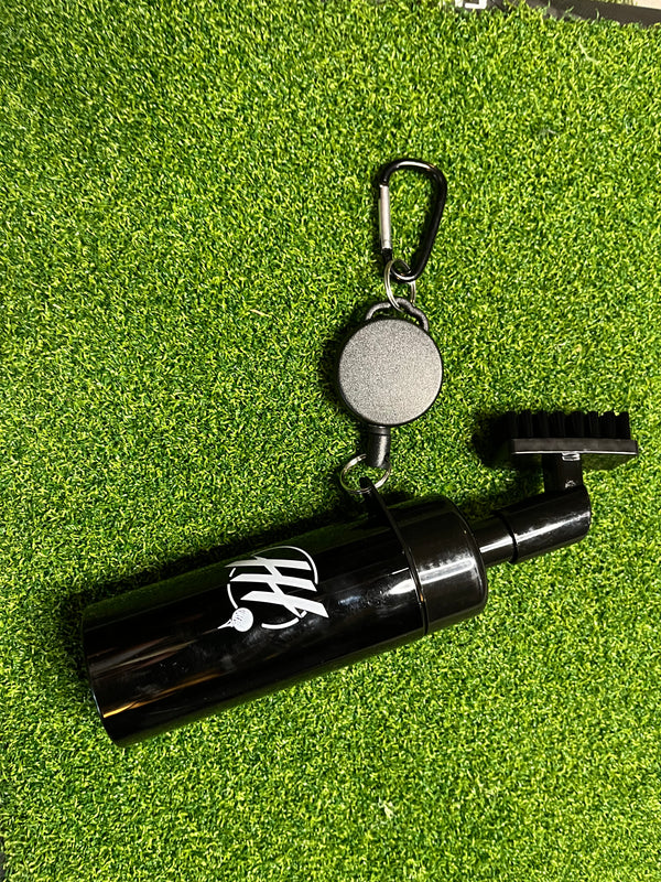 Golf club cleaning brush with spray bottle featuring a black design and carabiner for easy attachment