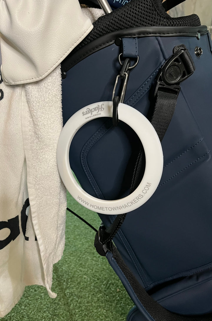 Hometown Hackers portable putting practice aid hanging from a golf bag for easy access during practice