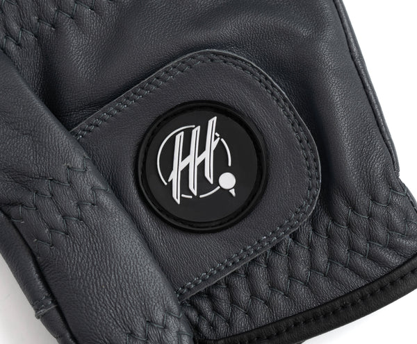Close-up of black premium golf glove for lefties with detailed stitching and logo patch