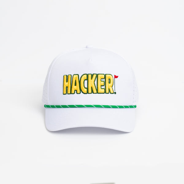 White premium golf hat with yellow HACKER embroidery and green striped trim across the brim